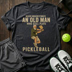 An Old Man Who Stills Plays Pickleball T-Shirt — Dark Heather