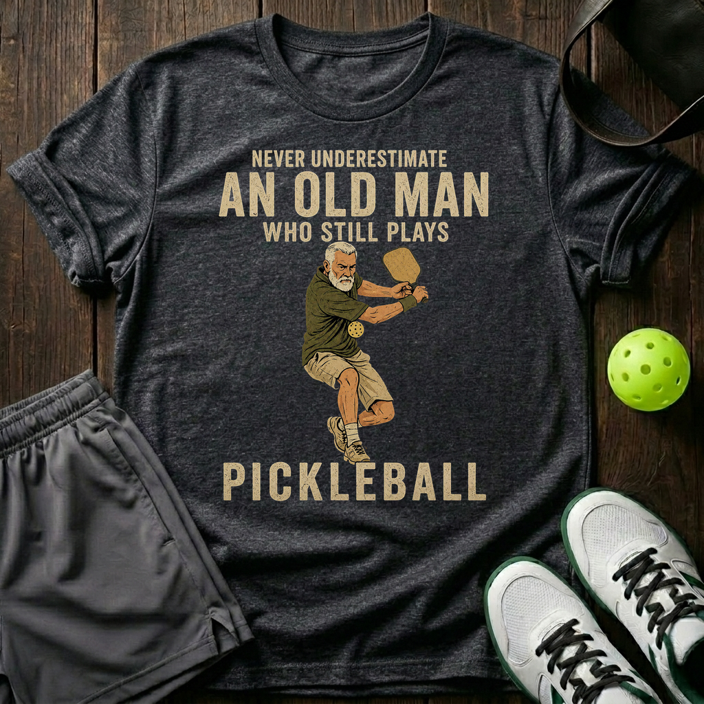 An Old Man Who Stills Plays Pickleball T-Shirt — Dark Heather